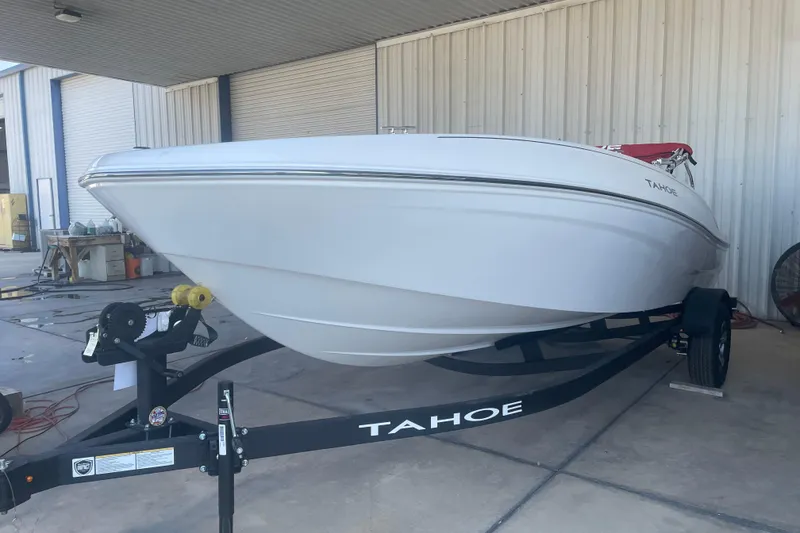 Slide: The Image of 2026 Tahoe T18 boat on trailer in a covered storage area. - 2