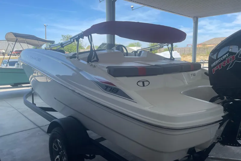 Slide: The Image of 2026 Tahoe T18 boat with Mercury Pro engine, parked under a canopy. - 3