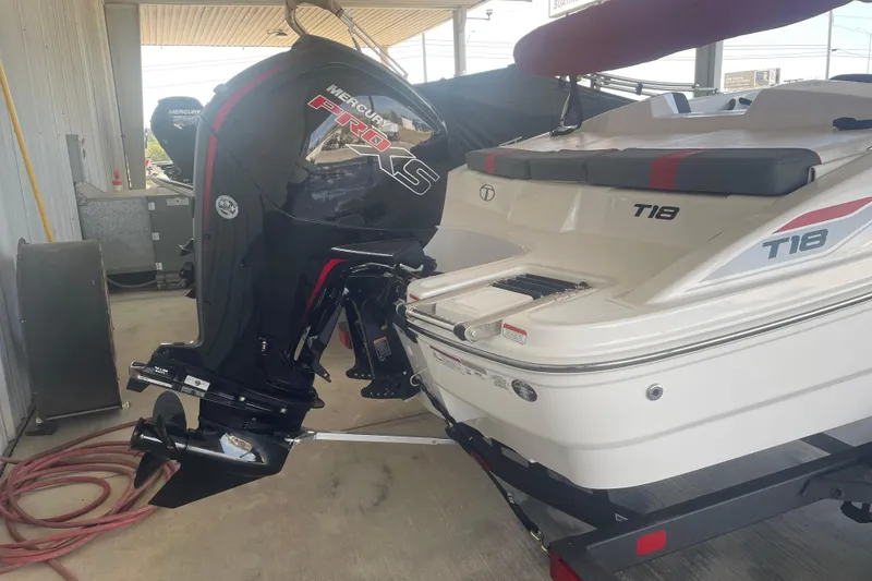 Slide: The Image of 2026 Tahoe T18 boat with Mercury Pro XS outboard motor in a covered area. - 5