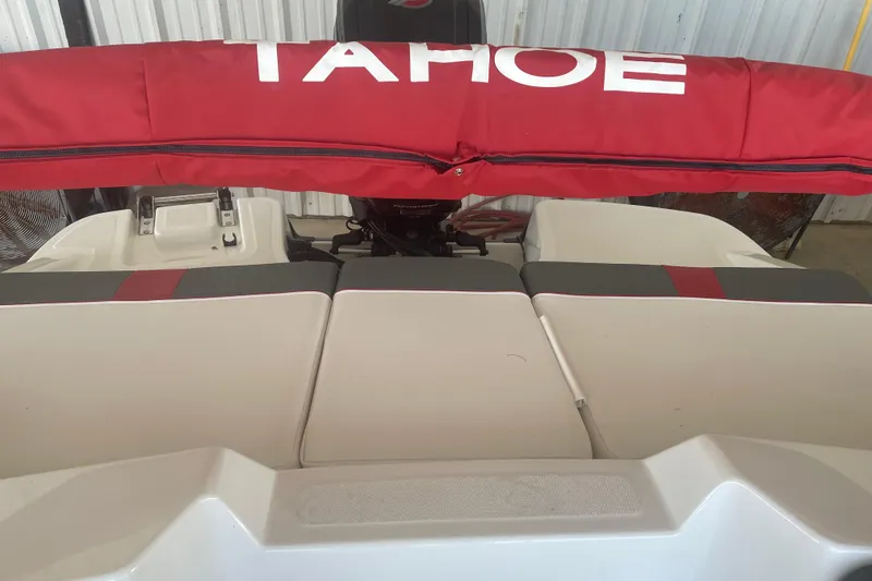 Slide: The Image of 2026 Tahoe T18 boat with red cover and cushioned seating. - 7