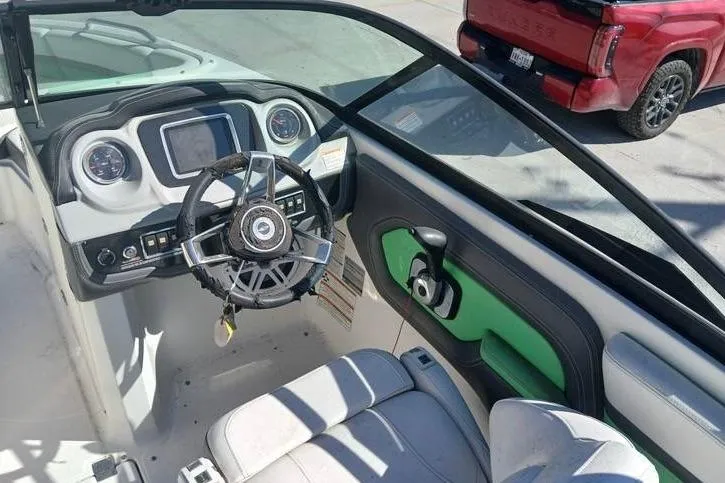 Slide: The Image of Interior view of a 2016 Chaparral Vortex 203 VR boat cockpit with steering wheel. - 10