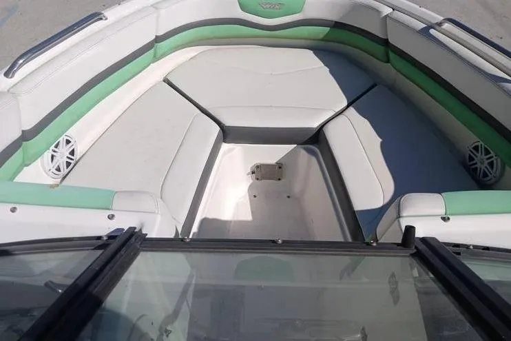 Slide: The Image of 2016 Chaparral Vortex 203 VR boat interior with green and white seating. - 12