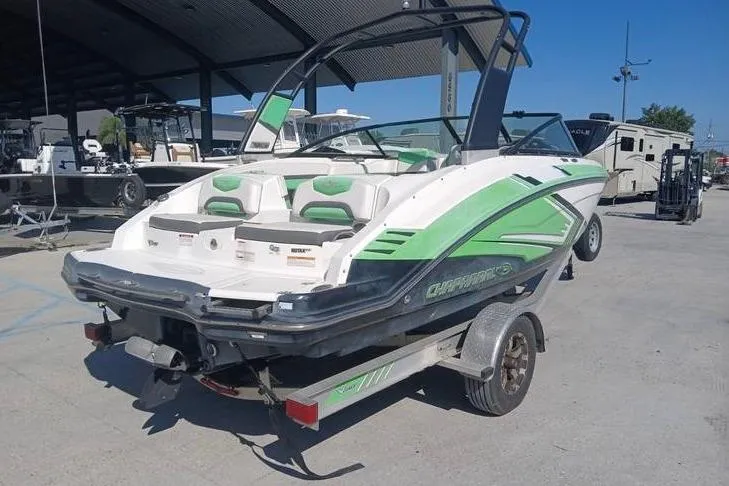 Slide: The Image of 2016 Chaparral Vortex 203 VR boat on trailer, green and white design, parked outdoors. - 3