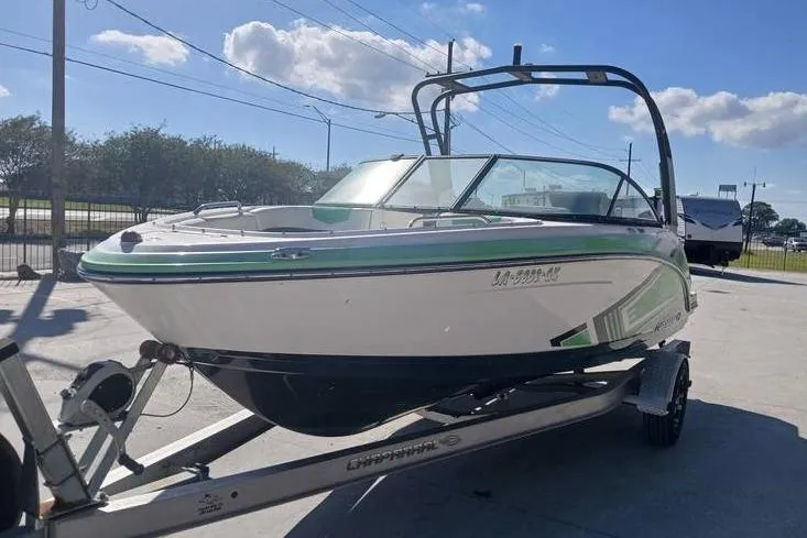 Slide: The Image of 2016 Chaparral Vortex 203 VR boat on trailer, parked outdoors under blue sky. - 5
