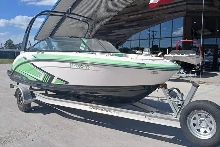 Slide: The Image of 2016 Chaparral Vortex 203 VR boat on trailer, green and white design, parked outdoors. - 6