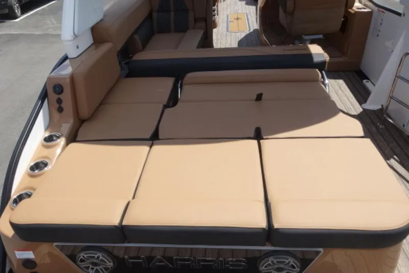 Slide: The Image of 2026 Harris Grand Mariner 250 boat with spacious tan seating and cup holders. - 12