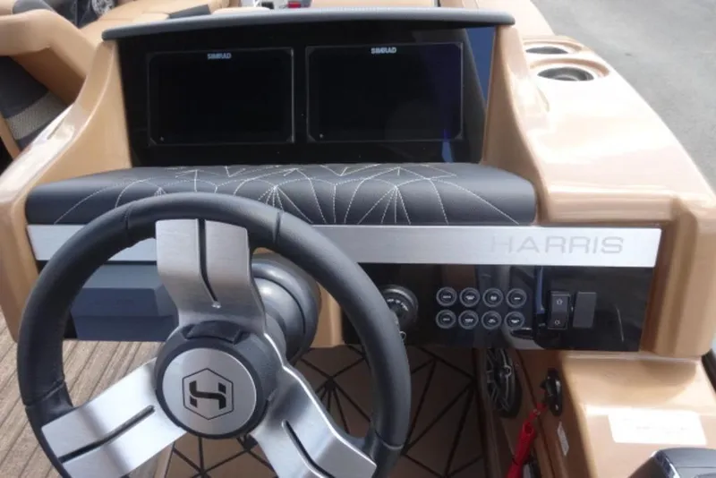 Slide: The Image of Steering console of 2026 Harris Grand Mariner 250 boat with modern controls and displays. - 9