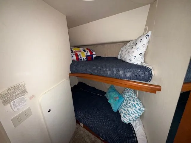 Slide: The Image of Bunk beds in 2004 Silverton 34 Convertible cabin with nautical-themed bedding. - 13