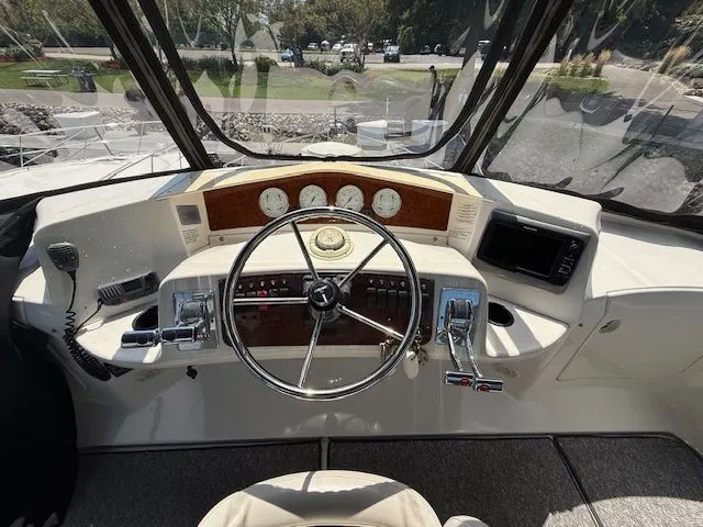 Slide: The Image of 2004 Silverton 34 Convertible helm with steering wheel, gauges, and navigation equipment. - 5