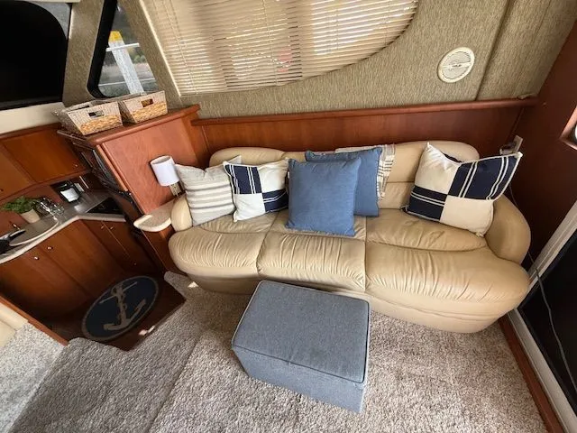 Slide: The Image of Interior of 2004 Silverton 34 Convertible with beige sofa and nautical-themed decor. - 8