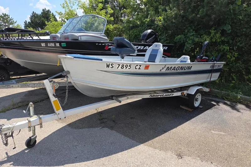 Slide: The Image of 1992 Smoker Craft 142 Magnum boat on trailer, parked outdoors. - 4