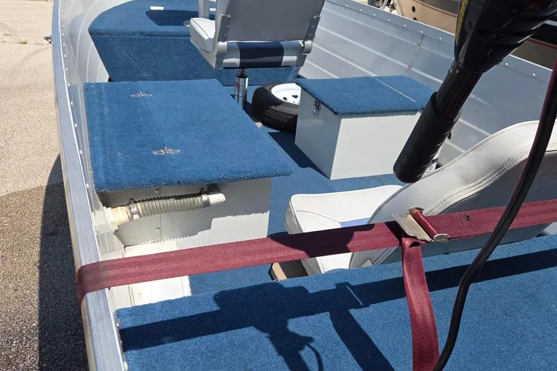 Slide: The Image of 1992 Smoker Craft 142 Magnum boat interior with blue carpet and seating. - 5