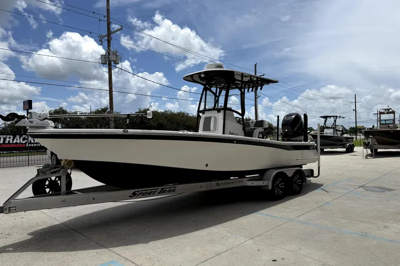 Slide: The Image of 2019 BlackJack 256 boat on trailer under blue sky with clouds. - 4