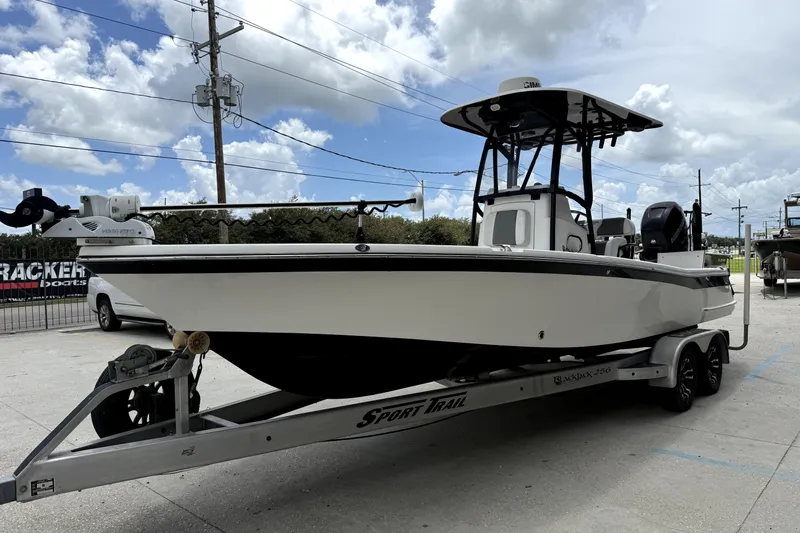 Slide: The Image of 2019 BlackJack 256 boat on trailer under cloudy sky. - 8