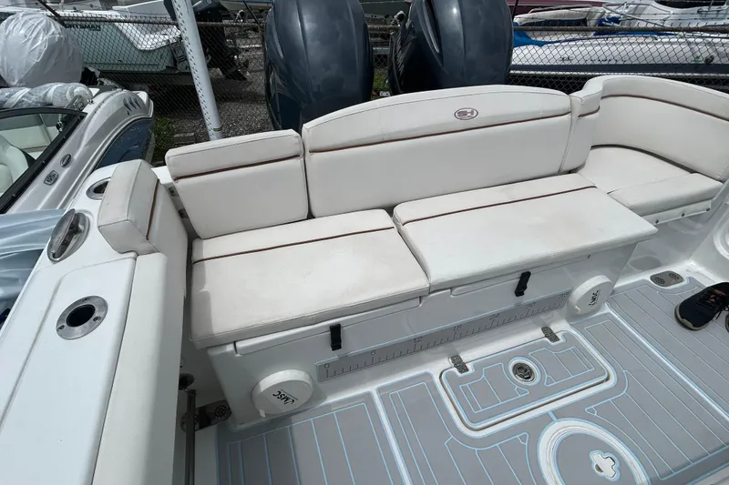 Slide: The Image of 2020 Sea Hunt Ultra 275 SE boat with white cushioned seating and deck view. - 12