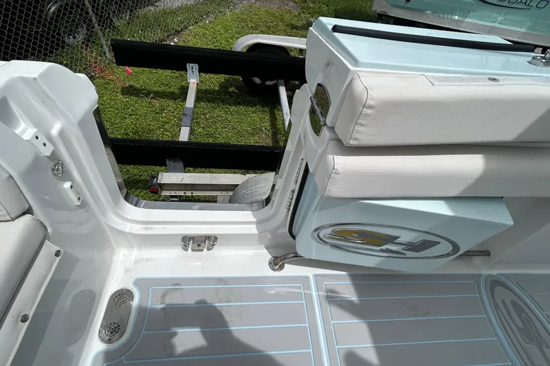 Slide: The Image of 2020 Sea Hunt Ultra 275 SE boat interior with cushioned seating and deck details. - 14