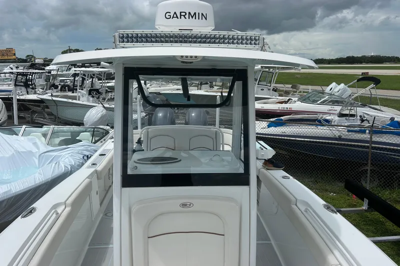 Slide: The Image of 2020 Sea Hunt Ultra 275 SE boat with Garmin equipment, docked among other boats. - 19