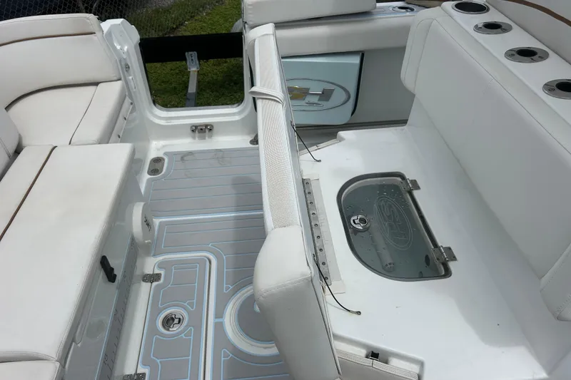 Slide: The Image of 2020 Sea Hunt Ultra 275 SE boat interior with white seating and storage compartments. - 20