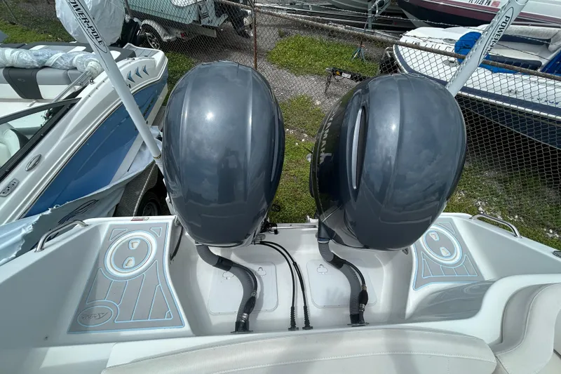 Slide: The Image of 2020 Sea Hunt Ultra 275 SE with dual outboard motors, docked at a marina. - 21