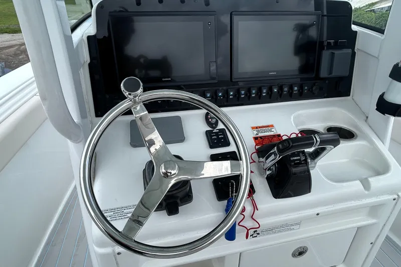 Slide: The Image of Control panel of a 2020 Sea Hunt Ultra 275 SE boat with steering wheel and displays. - 6