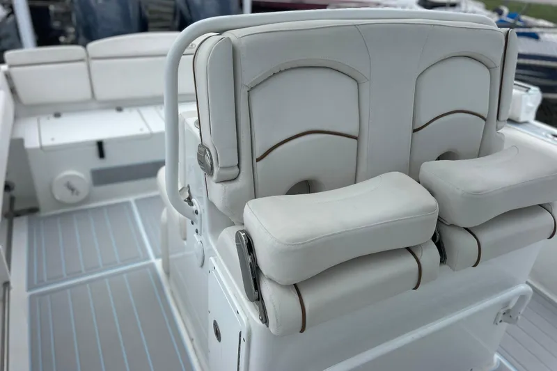 Slide: The Image of 2020 Sea Hunt Ultra 275 SE boat interior with white cushioned seating. - 8