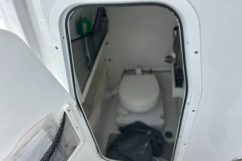 Slide: The Image of 2020 Sea Hunt Ultra 275 SE boat interior with compact marine toilet. - 9