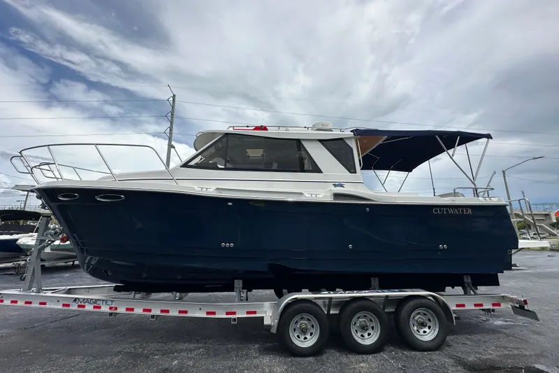 Slide: The Image of 2020 Cutwater C-28 boat on trailer under cloudy sky. - 10