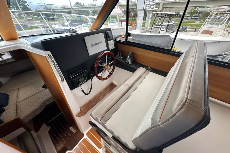 Slide: The Image of 2020 Cutwater C-28 boat interior with Garmin navigation system and comfortable seating. - 28