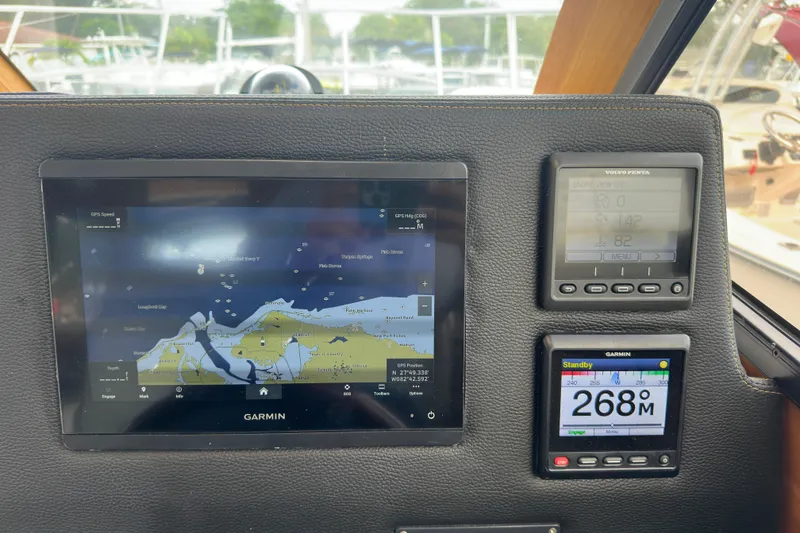Slide: The Image of Cutwater C-28 2020 dashboard with Garmin navigation and Volvo Penta engine displays. - 30