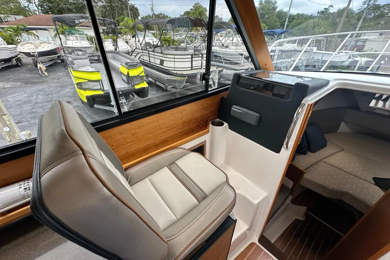 Slide: The Image of Interior view of a 2020 Cutwater C-28 boat with helm seat and cabin area. - 32