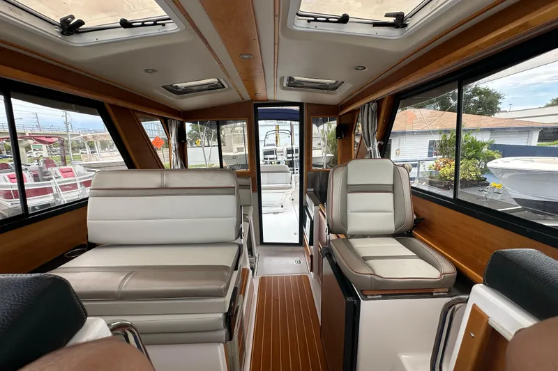 Slide: The Image of Interior of a 2020 Cutwater C-28 boat, featuring comfortable seating and wood accents. - 33