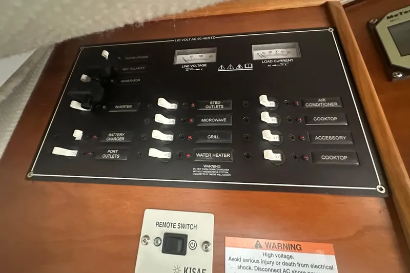 Slide: The Image of Electrical control panel on a 2020 Cutwater C-28 boat, featuring various switches and warnings. - 38