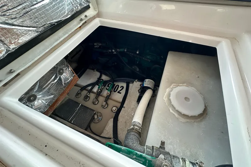 Slide: The Image of Engine compartment of a 2020 Cutwater C-28 boat, showing mechanical components and wiring. - 42