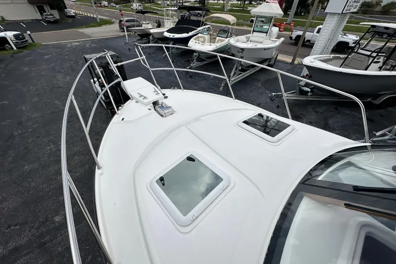 Slide: The Image of 2020 Cutwater C-28 boat deck with hatches, docked among other boats. - 43