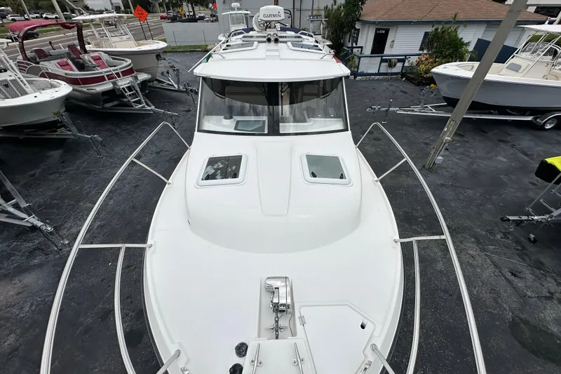 Slide: The Image of 2020 Cutwater C-28 boat on display, surrounded by other boats in a showroom. - 46