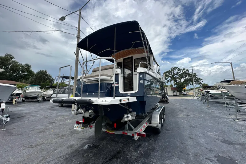 Slide: The Image of 2020 Cutwater C-28 boat on trailer, parked in marina under cloudy sky. - 5