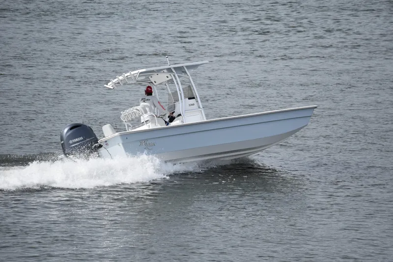 Slide: The Image of 2025 KenCraft 2260 Bay Rider Skiff cruising on water. - 3