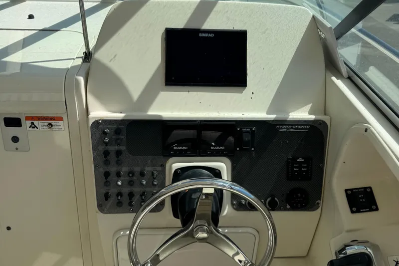 Slide: The Image of 2005 Hydra-Sports Vector 2500 VX boat dashboard with steering wheel and control panel. - 12