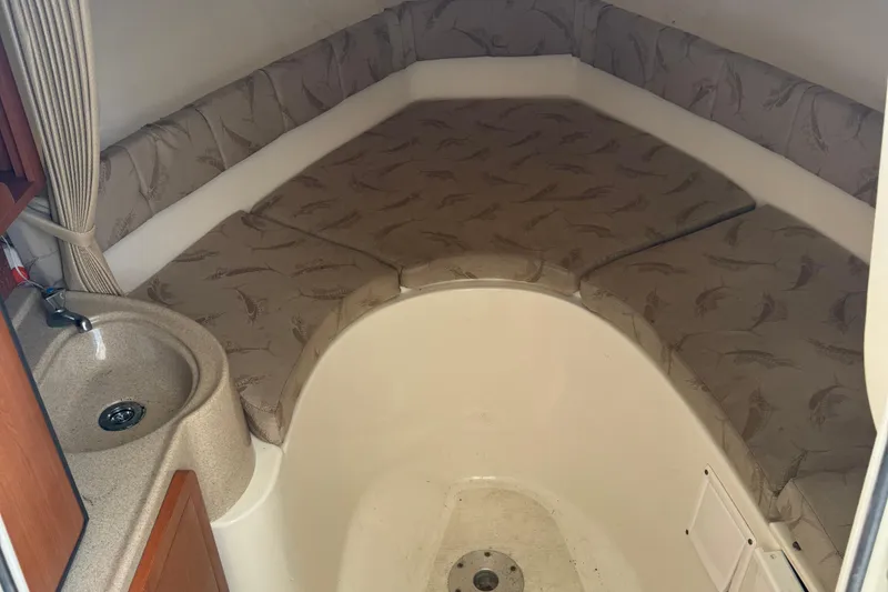 Slide: The Image of 2005 Hydra-Sports Vector 2500 VX cabin interior with sink and cushioned seating. - 5