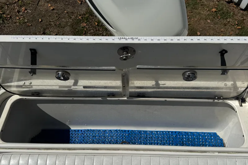 Slide: The Image of Open storage compartment on 2005 Hydra-Sports Vector 2500 VX boat with measuring ruler. - 8