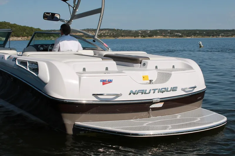 Slide: The Image of 2008 Air Nautique Crossover 236 boat on a lake, rear view with driver. - 19