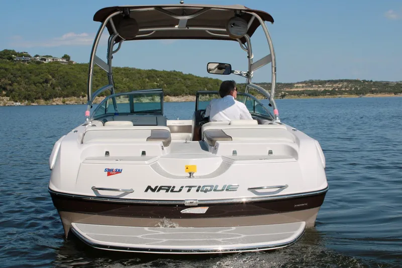 Slide: The Image of 2008 Air Nautique Crossover 236 boat on a lake, rear view with driver. - 20