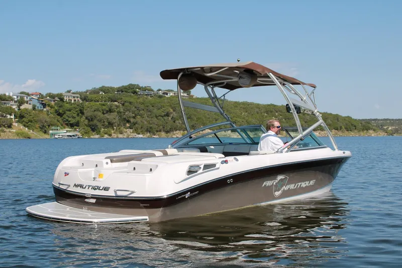 Slide: The Image of 2008 Air Nautique Crossover 236 boat on a lake with scenic background. - 22