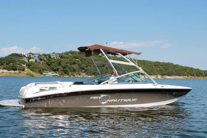 Slide: The Image of 2008 Air Nautique Crossover 236 boat on a lake with scenic background. - 24