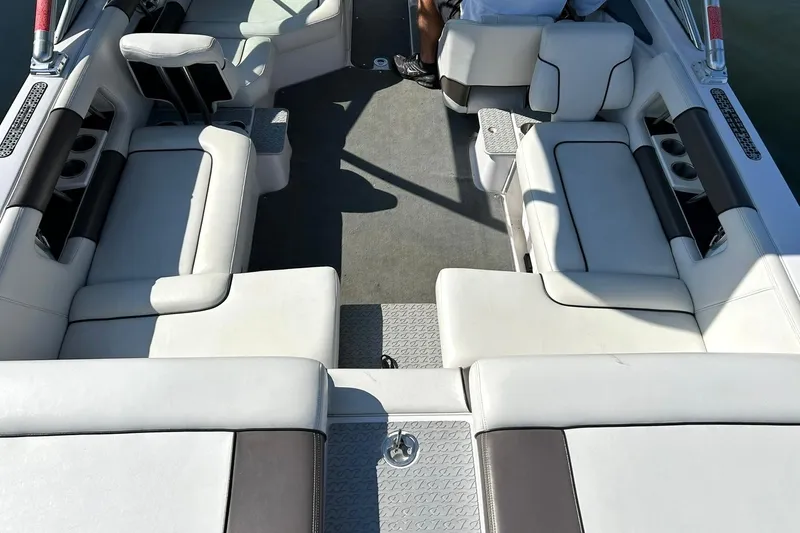 Slide: The Image of 2008 Air Nautique Crossover 236 boat interior with white seating and cup holders. - 26