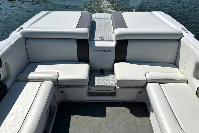 Slide: The Image of 2008 Air Nautique Crossover 236 boat interior with white seating and water backdrop. - 27