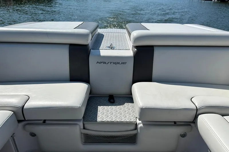 Slide: The Image of 2008 Air Nautique Crossover 236 boat interior with cushioned seating and water view. - 28