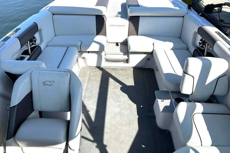 Slide: The Image of 2008 Air Nautique Crossover 236 boat interior with white leather seating and cup holders. - 3