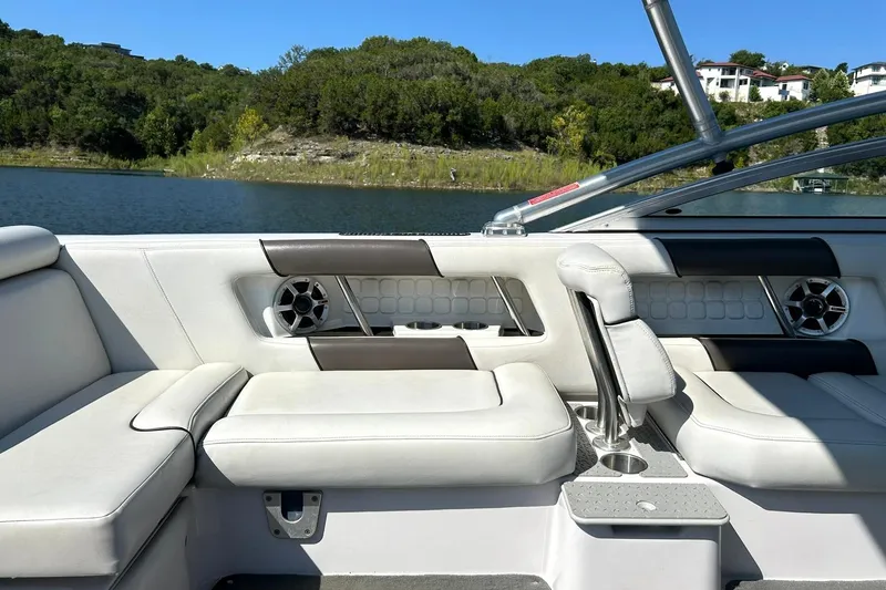 Slide: The Image of 2008 Air Nautique Crossover 236 boat interior with white seating and lake view. - 32