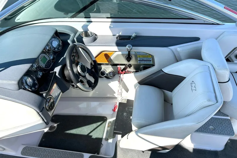 Slide: The Image of 2008 Air Nautique Crossover 236 boat interior with steering wheel and dashboard controls. - 38